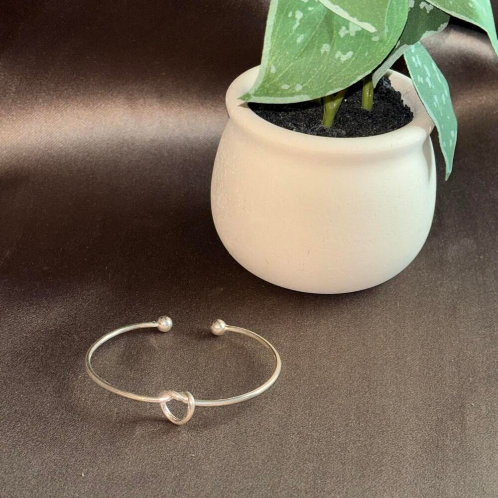 Silver bangle bracelet with knot